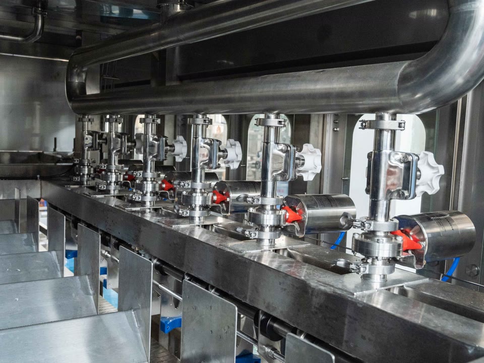 Close-up of stainless steel sanitary tri-clamp filling valves