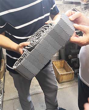 Yang, Factory Director at Linho Machinery, inspecting a machine part
